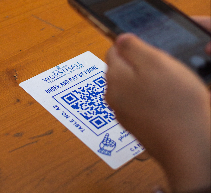 Contactless ordering became popular in 2021, with the advent of QR codes in restaurants. In this picture a restaurant patron uses their smartphone to view a menu.